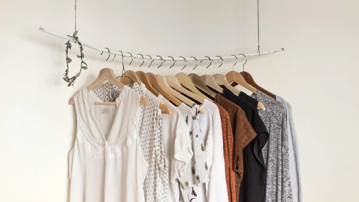 Colorful clothing on hangers — digital closet organizer apps and wardrobe management